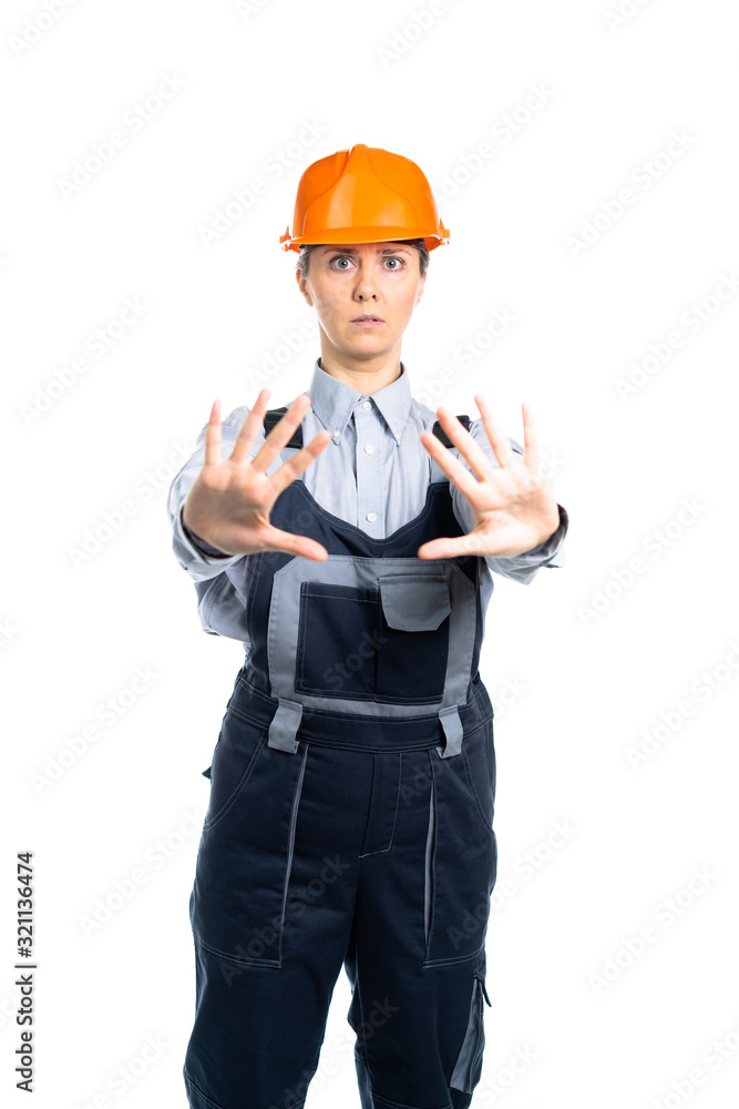 Female engineer builder shows hand gestures STOP. Isolated Female engineer builder shows hand gestures STOP. Isolated