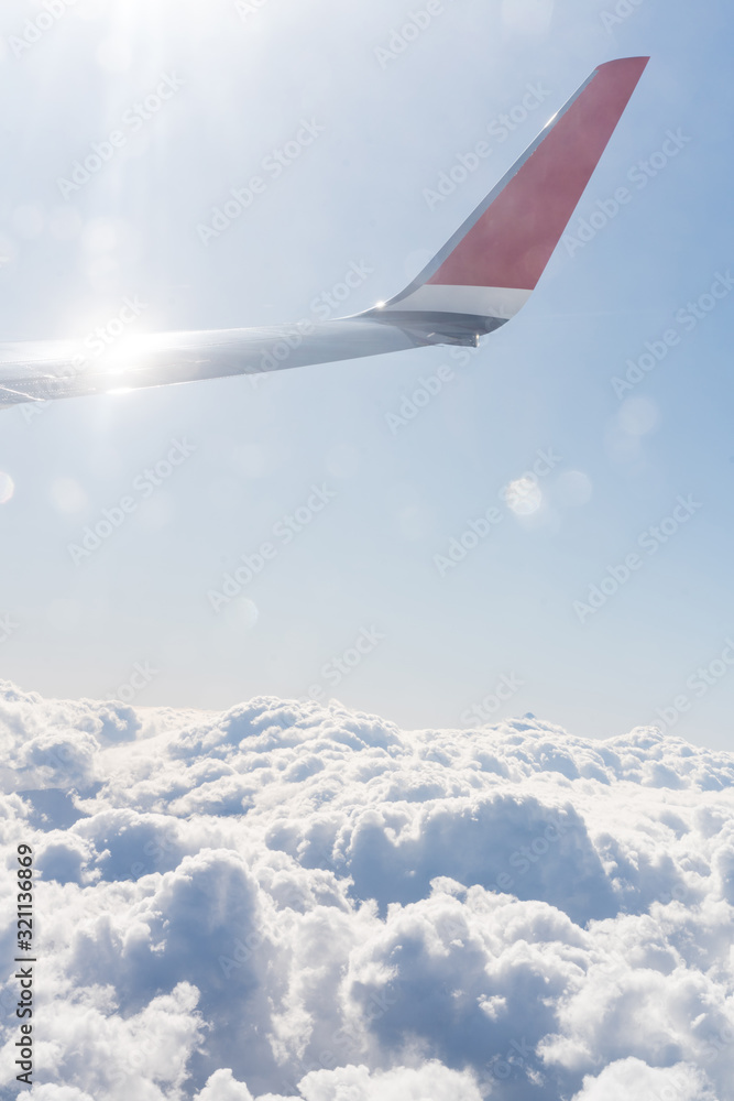 Fototapeta premium Wing aircraft in blue clear sky during flight