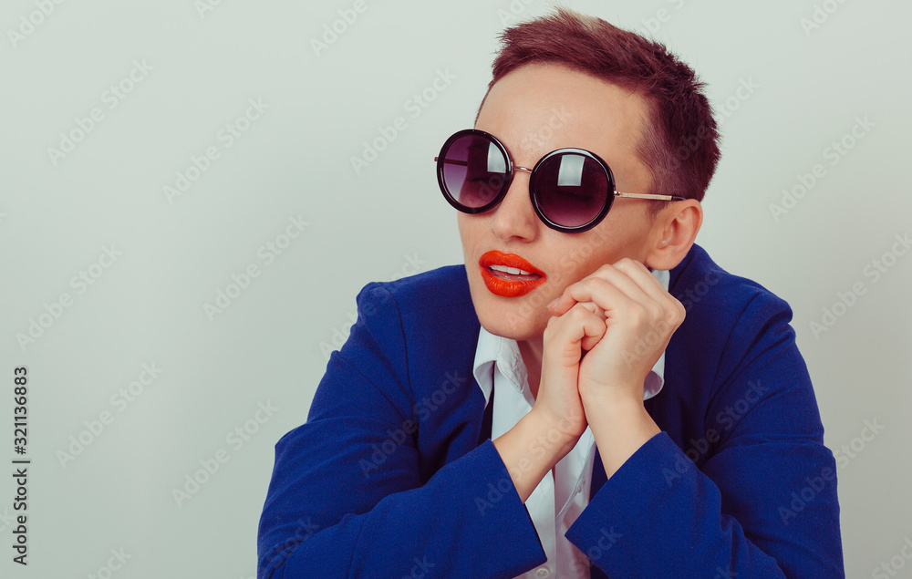 Woman in sunglasses posing isolated on a yellow background Woman in sunglasses posing isolated on a yellow background