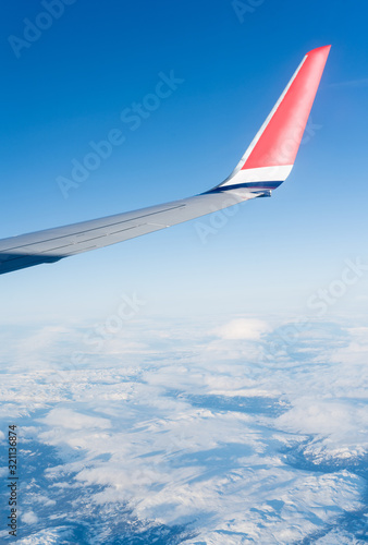 Wing aircraft in blue clear sky during flight
