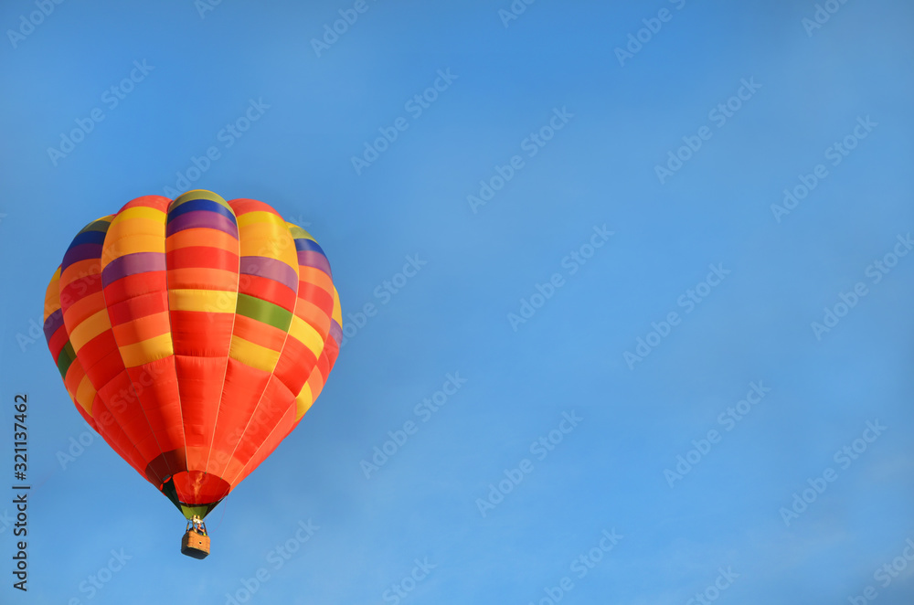 multi-colored beautiful bright hot air balloon in the blue sky multi-colored beautiful bright hot air balloon in the blue sky