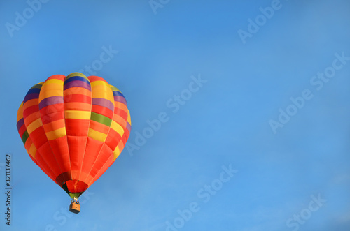 multi-colored beautiful bright hot air balloon in the blue sky