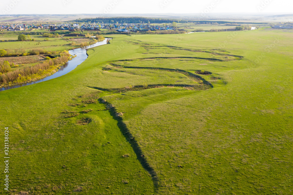 Beautiful grazing at river floodplain. Aerial drone view from above