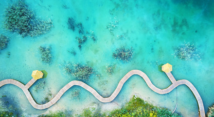 Gordijnen Koraalgroen Aerial landscape from the drone - blue water and wooden bridge park Grodek in Jaworzno, Poland  © Piotr Krzeslak