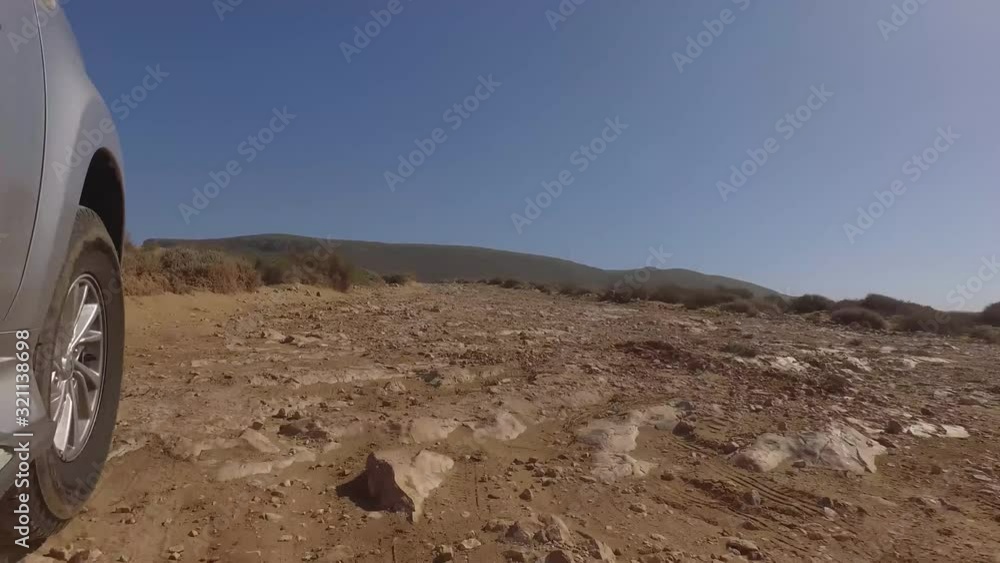 Cropped image of car moving on dirt road against clear sky, Sidi Ifni, Guelmim-Oued Noun, Morocco Cropped image of car moving on dirt road against clear sky, Sidi Ifni, Guelmim-Oued Noun, Morocco