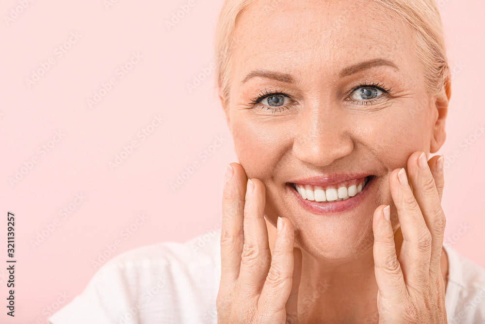 Beautiful mature woman with healthy skin on color background Beautiful mature woman with healthy skin on color background