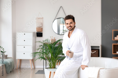 Handsome young man drinking...