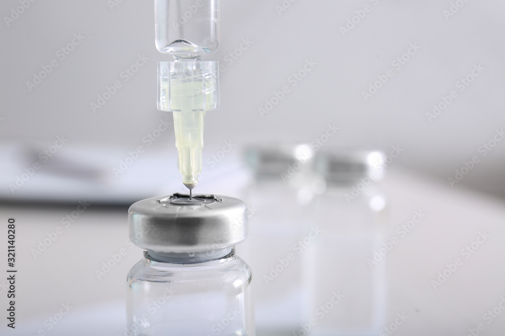 Syringe with filler for cosmetology and ampule, closeup Syringe with filler for cosmetology and ampule, closeup