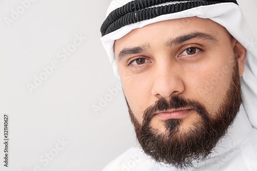 Handsome Arab man on light background photo