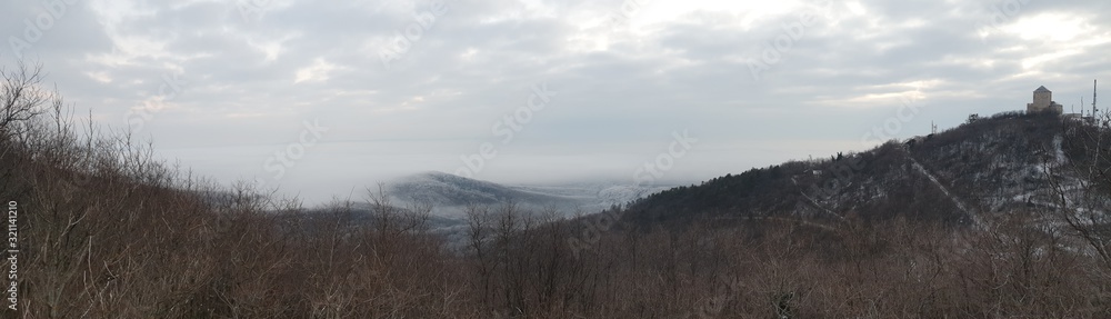 Panorama of hills with fog in the lowlands