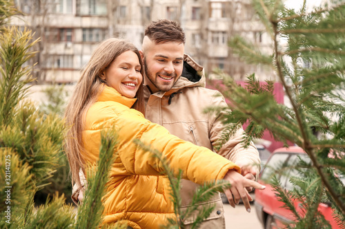 Young couple buying Christm...