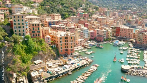 Aerial view of Camogli harbor. Colorful buildings near the ligurian sea beach, Italy. View from above on boats and yachts moored in marina with green blue water. photo