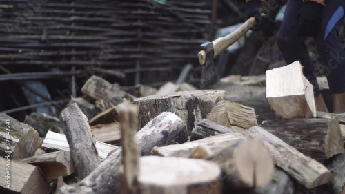 Wallpaper Mural Man chops wood outdoors in slow motion. Man's hands working with ax. A man woodcutter chops tree trunks with an ax for firewood. Torontodigital.ca