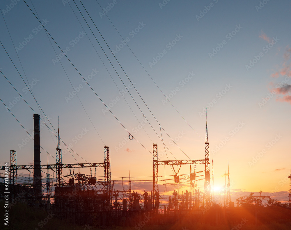 Power lines during a beautiful sunset. Transportation of electricity through the beautiful landscapes of the world