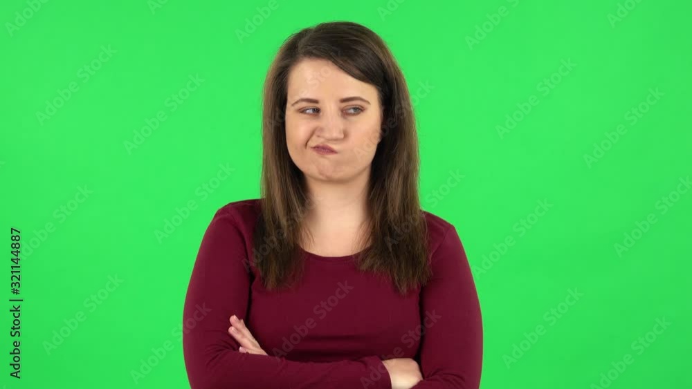 Portrait of pretty girl is very offended and looking away . Green screen Portrait of pretty girl is very offended and looking away . Green screen