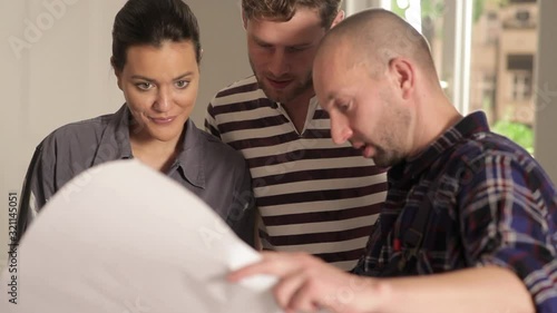 CU, R/F, Handheld of young couple and a contractor reviewing blueprints