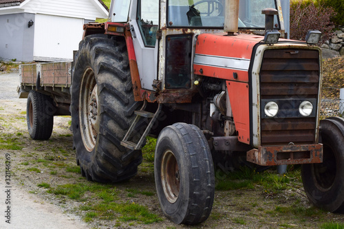 Red tractor with a trailer. Agricultural machinery.