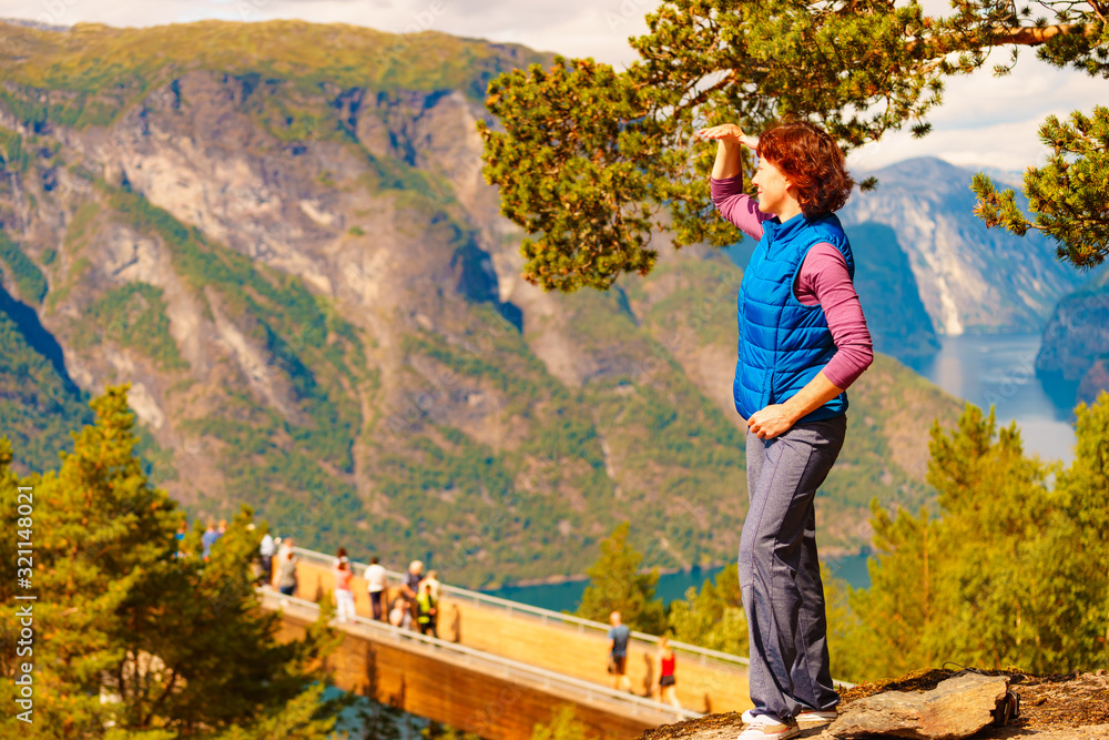 Naklejka premium Tourist enjoying mountains fjord view, Norway