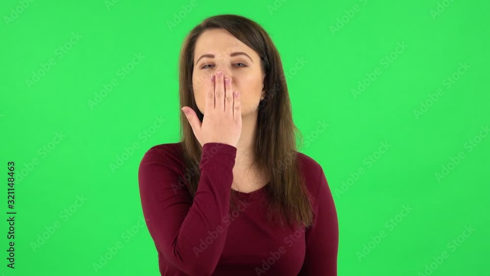 Portrait of pretty girl smiling and showing heart with fingers then blowing kiss. Green screen Portrait of pretty girl smiling and showing heart with fingers then blowing kiss. Green screen