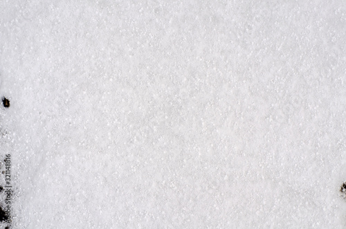 Background of fresh snow white natural texture pattern for minimalistic design in grey tone. Top view witn snowflakes and large cereals. Concept of abstract winter surface with copy space for text