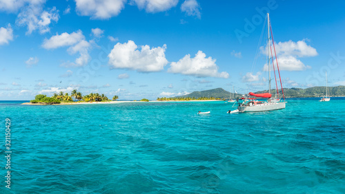 Turquoise sea and anchored yachts near Carriacou island, Grenada, Caribbean sea photo
