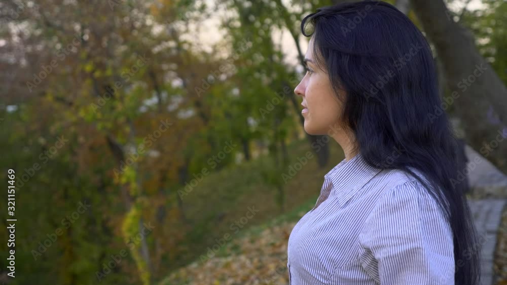 Beautiful Girl Standing And Thinking In The City Park On The Hill. Looking On Evening (Morning) Sky Above Cityscape. Summer Autumn Season Beautiful Girl Standing And Thinking In The City Park On The Hill. Looking On Evening (Morning) Sky Above Cityscape. Summer Autumn Season