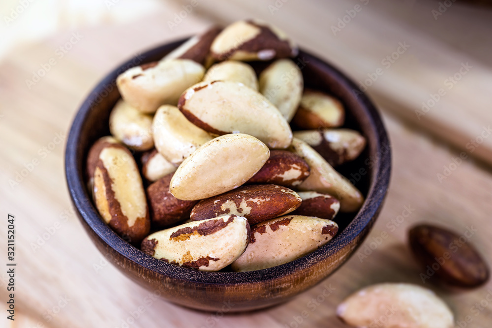 small rustic wooden pot with peeled Brazil nuts. Brazil nut, healthy food. small rustic wooden pot with peeled Brazil nuts. Brazil nut, healthy food.