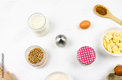 Baking ingredients and utensils on white background. Cooking or baking cake, cookies, pastry or bread concept. Top view, recipe, menu