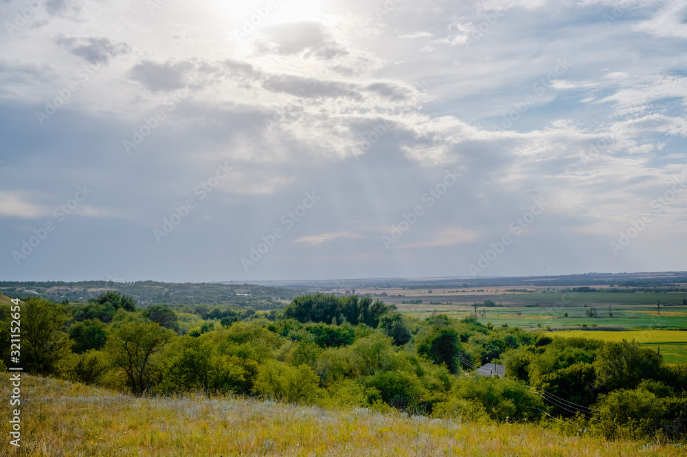 View from the hill to the green valley in cloudy weather.