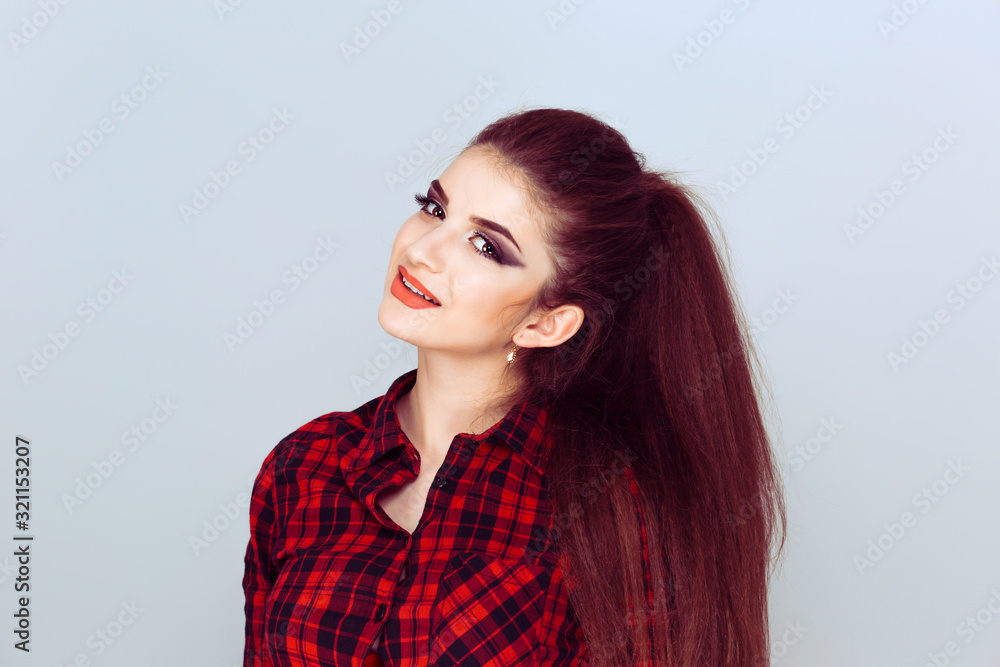 Happy, young and healthy. Closeup young brunette woman with long hair showing toothy smile isolated on light blue wall background. Happy, young and healthy. Closeup young brunette woman with long hair showing toothy smile isolated on light blue wall background.