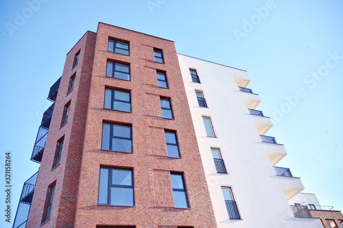 Contemporary residential building exterior in the daylight. Modern and new apartment building. 