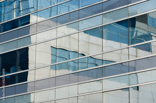 Buildings that are reflected in another generating an image of lines and color