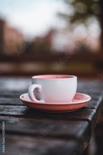 Beautiful pink teacup in on the table.