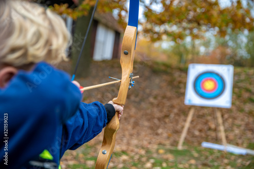 Fotografia Children shot on target during a competition in archery in the forest