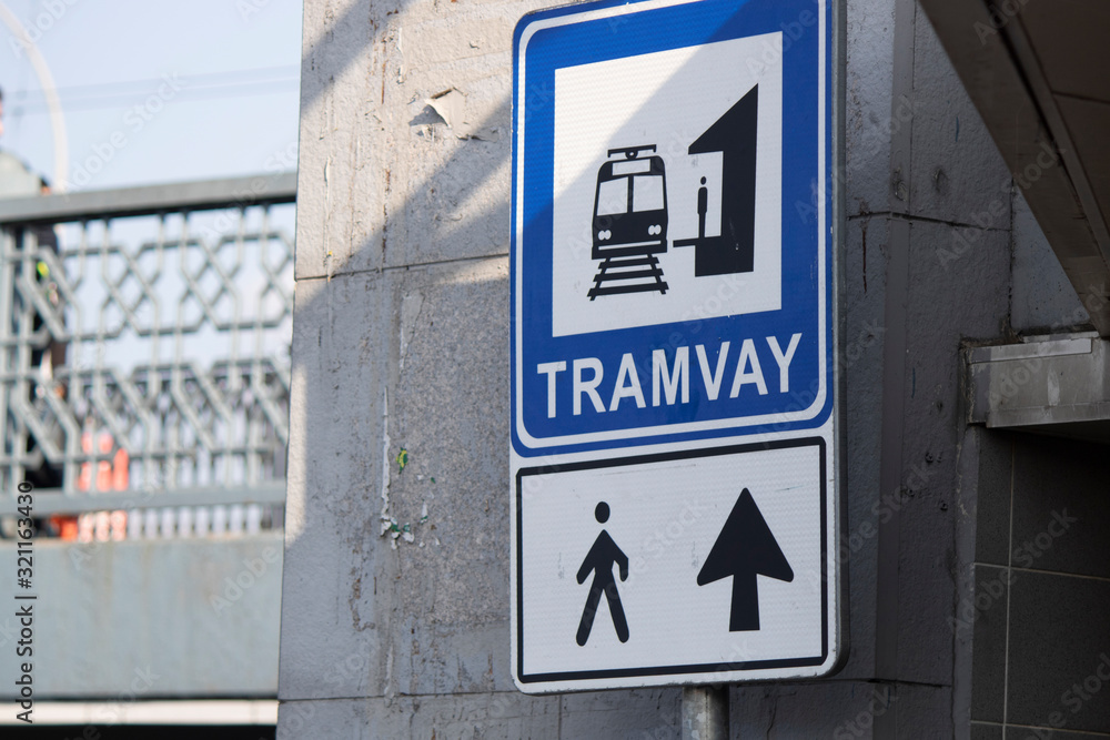 Signboard close-up showing the direction of the tram station.