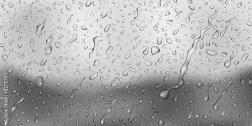 Background with drops and streaks of water in gray colors, flowing down the surface