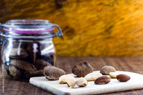 Brazil nuts, Amazon nuts, Brazil nuts, Bolivian nuts, Toquei or Tururi, very abundant in northern Brazil and Bolivia. wooden background, space for text. photo