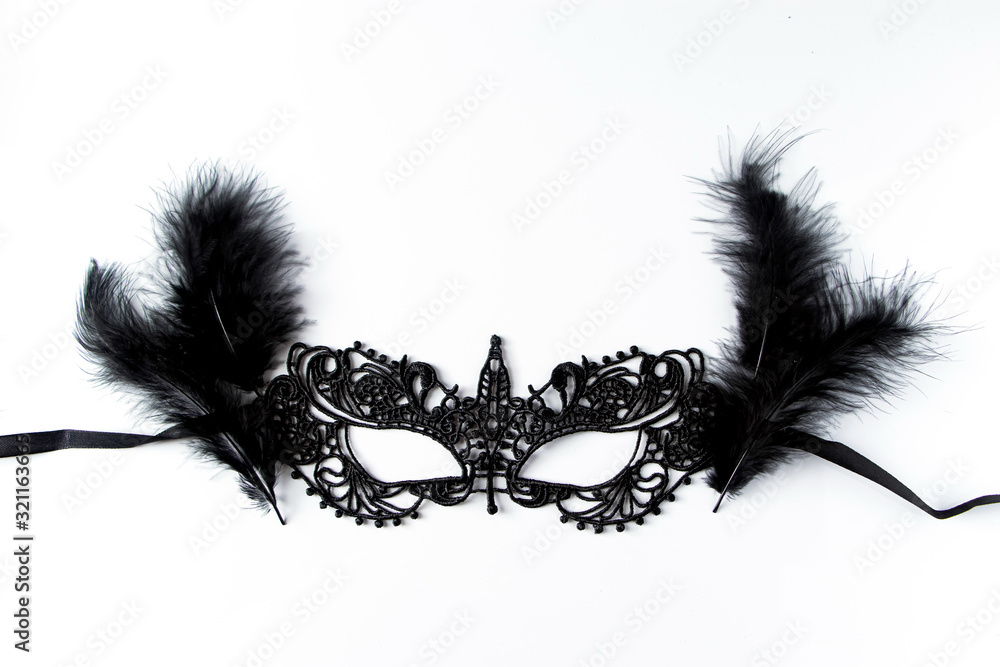 Fototapeta Beautiful carnival mask of black lace on a white background.