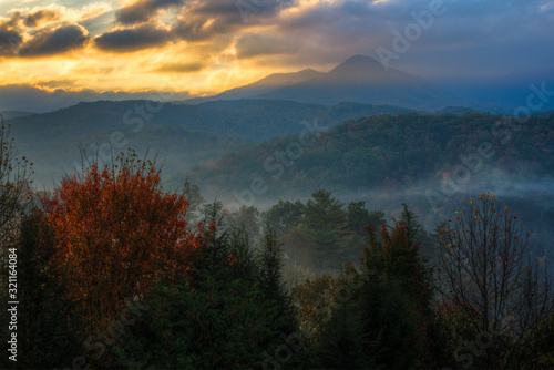 Dawn light breaks through storm clouds over the Smoky Mountains.