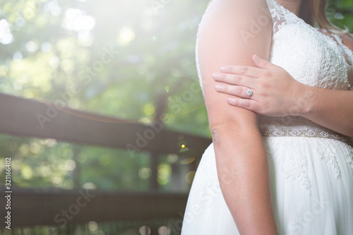 Bride showing off ring on nature trail 