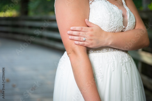 Bride showing off wedding ring in summer