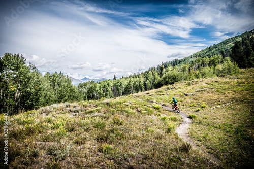 mountain biking across mountain meadow