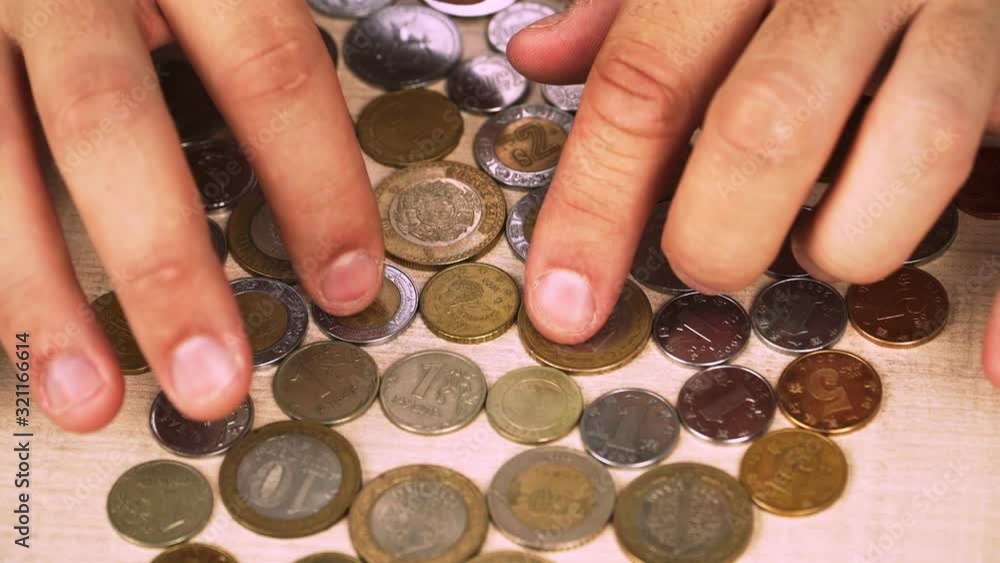 Many coins from different countries. Yuan, Mexican peso, cent, ruble, Georgian lari. Money. Close-up Many coins from different countries. Yuan, Mexican peso, cent, ruble, Georgian lari. Money. Close-up