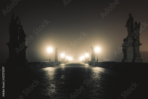 View of the Charles Bridge in Prague on Misty Night