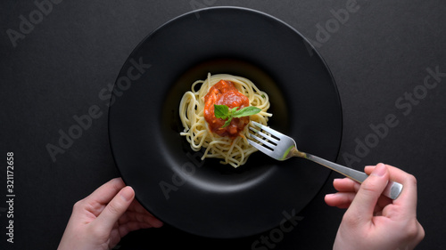 Top view of a woman with fork ready to eat spaghetti