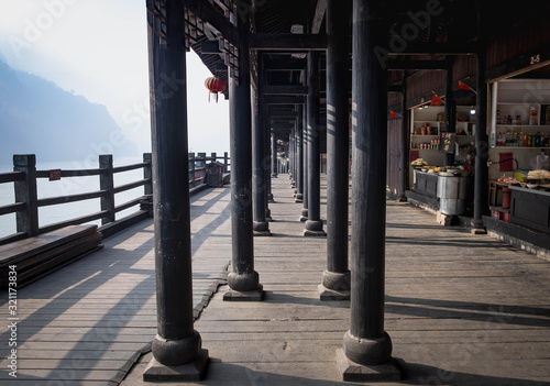 The wooden village along with the hill beside the Yangtze river in the part of Three Gorges Dam.