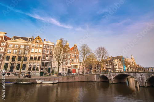 Amsterdam Netherlands, city skyline at canal waterfront and bridge with traditional house © Noppasinw