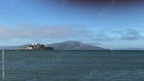 Alcatraz prison standing strong on its rocky island with birds flying around photo