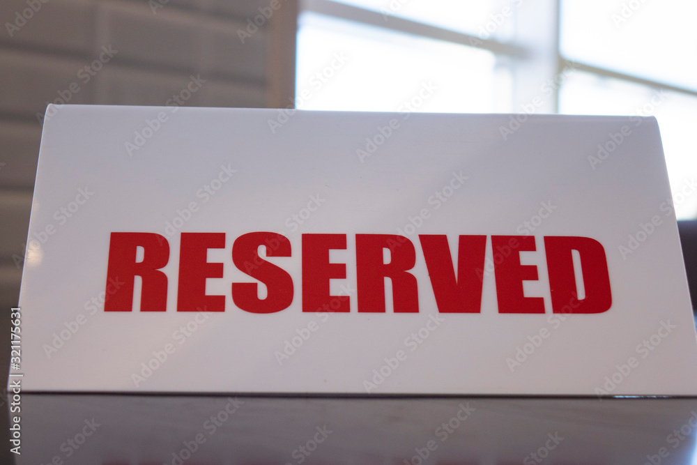 A sign that says reserved on a table in a restaurant or cafe, selective focus. A sign that says reserved on a table in a restaurant or cafe, selective focus.