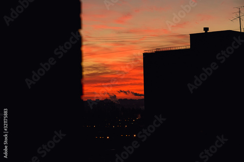 red sky of dawn view from the window in the city